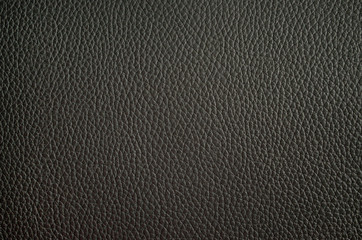 Leather texture close up. Black fashionable background, top view. Stylish wallpaper of gray color. Rough surface.