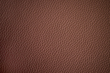 Leather texture close up. Brown fashionable background, top view. Stylish wallpaper of chocolate color. Rough surface.	