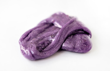 Isolated violet slim lies a pile on a white background