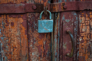 old iron rusty lock on a wooden door