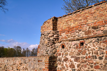 Fototapeta na wymiar Medieval defensive wall of stones and bricks in the city of Osno in Poland.