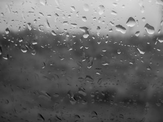 Raindrops on the car window. Blurred landscape behind the window. Autumn scene that is nostalgic.