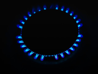 Natural gas with a burning blue flame. The concept of danger, economy, gas. With place for your text, lettering.