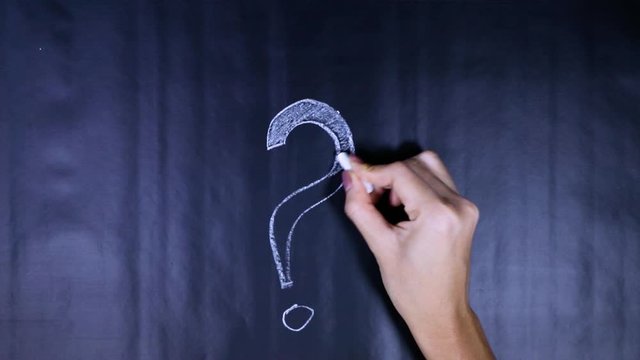Time lapse of woman hand drawing question mark on chalkboard