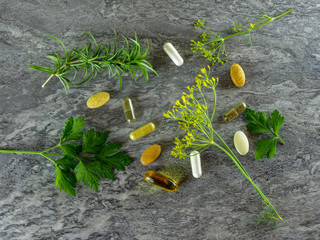 drugs pills food suplements healthy medicine medication health care treatment additives pharmacy pharmaceutical industry at grey background WITH GREEN PLANTS