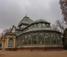 Fototapeta na wymiar Crystal Palace in Retiro Park in Madrid at dawn on a cloudy day. Concepto viajes.