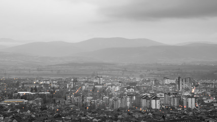 Beautiful desaturated Pirot cityscape, murky weather and distant mountains