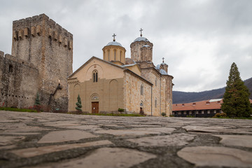 Fototapeta na wymiar Beautiful orthodox Manasija monastery, surrounded by protective fortress walls, with wooden entrance doors, famous symbol of Christianity and popular travel destination