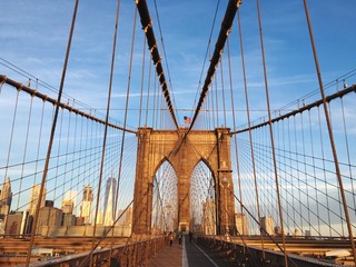 Brooklyn Bridge In City Against Blue Sky