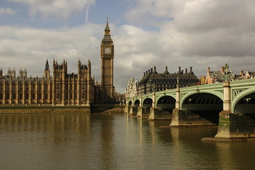 Naklejka na ściany i meble Westminster Bridge Over Thames River By Big Ben Against Cloudy Sky