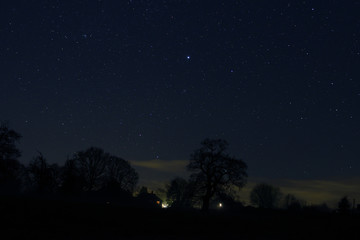 Fototapeta na wymiar Starry night over small houses in Herefordshire countryside