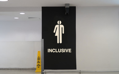 Inclusive restroom sign with a graphic symbol and the word, 
