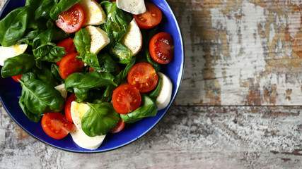 Fresh caprese salad with cherry tomatoes. Healthy salad with basil and mozzarella. Diet food. Keto diet.