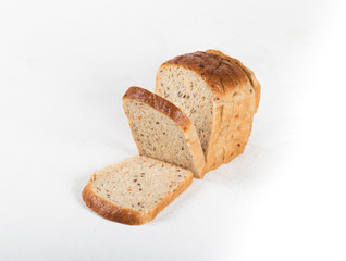 Whole grain fitness bread with dried carrots and flax, pumpkin, and sunflower seeds, sliced on a light background
