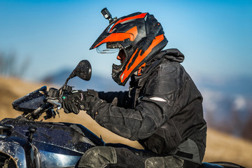 Multiple quad bikes riding through snow and mud terrain