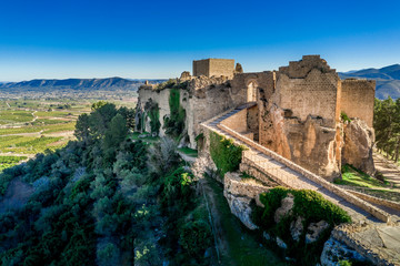 Fototapeta na wymiar Aerial view of medieval ruined Montesa castle center of the Templar and Montesa order knights with donjon, long ramp to the castle gate in Spain