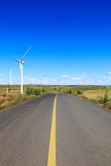 Fototapeta premium Asphalt road and wind turbines