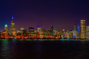 Chicago skyline at night by Lake Michigan.
