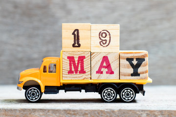 Truck hold letter block in word 19may on wood background (Concept for date 19 month May)