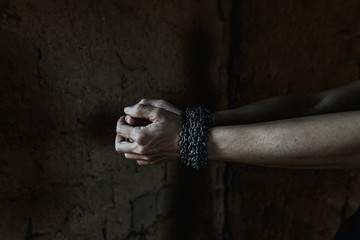Young man desperate to catch the iron prison,prisoner concept,Handcuffed hands of a prisoner in...
