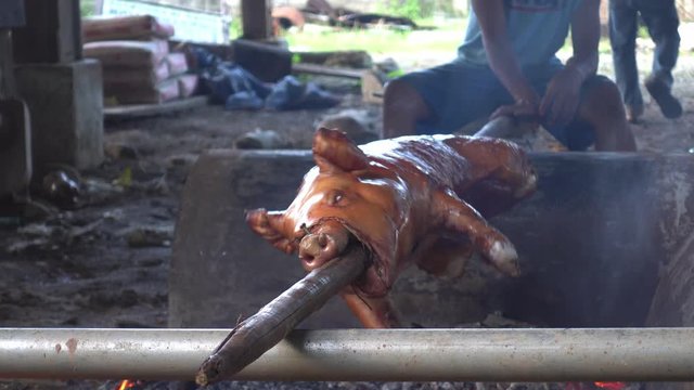 Lechon roast pig being cooked finely on a traditional stove in Philippines
