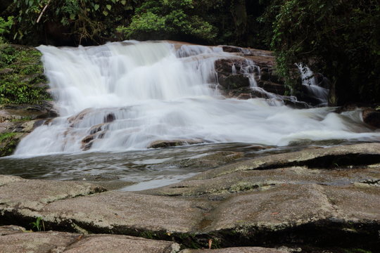 Paraty/Rio de Janeiro/Brazil - Pedra Branca waterfall, touristic place. Cold water runs through the rocks. It's located in a private area