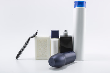 Men's personal care kit. Photo was taken in the studio on white background. Consists of bottles and shaving supplies. Close up.