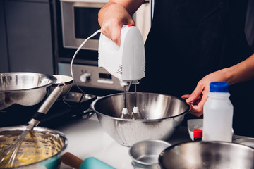 Woman beat dough mixer by machine