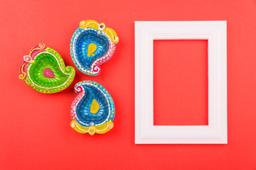 Happy Diwali Day, Flat lay top view Colorful Clay Diya lamps and photo frame