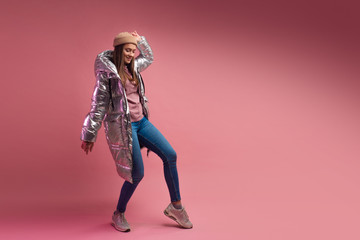 stylish and daring young girl in a silver down jacket