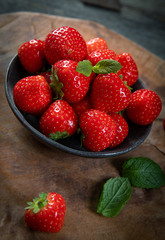 Fresh picked tasty strawberries on wooden background