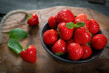 Fresh picked tasty strawberries on wooden background