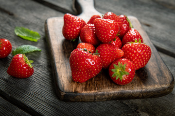 Fresh picked tasty strawberries on wooden background
