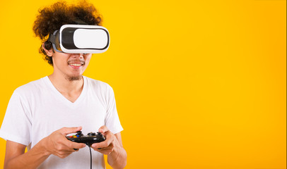 Asian handsome man with curly hair play game he using virtual reality headset or VR glass