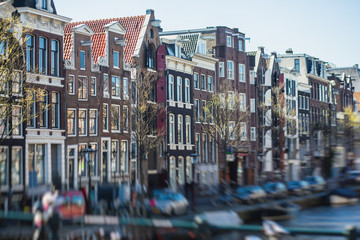 View of Amsterdam street in the historical center, with canal houses in the capital city of Amsterdam, North Holland, Netherlands, summer sunny day