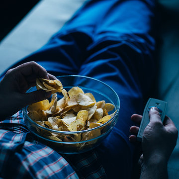 Overeating, Sedentary Lifestyle, Bad Habits, Food Addiction, Eating Disorders. Fat Overweight Man Lay On The Coach With Tv Remote And Junk Food. Depression, Laziness