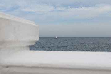 Fototapeta premium white sail alone in the mist of the blue sky that he is looking for the edge of the far