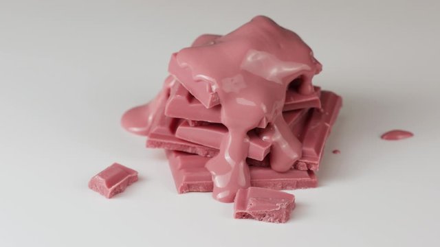 Melted ruby chocolate pouring into a piece of chocolate bars 