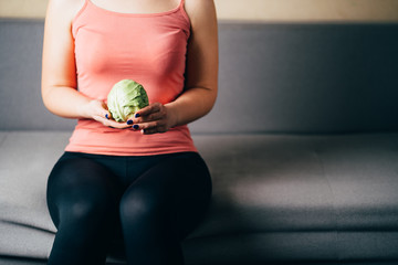 Fit woman with cabbage. Diet, healthy food, anorexia orthorexia concept