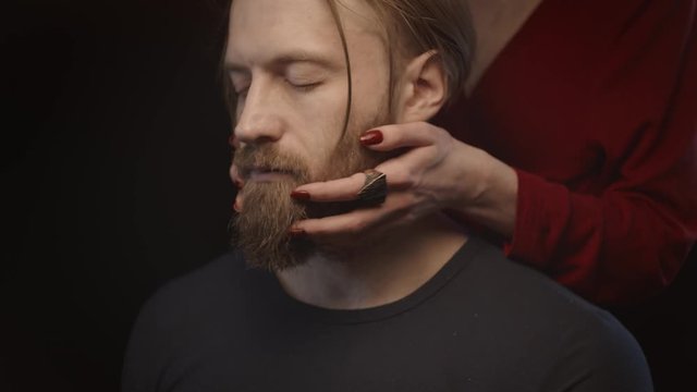 Woman touching man's beard, slow motion
