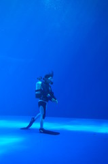 Diver swimming in blue underwater