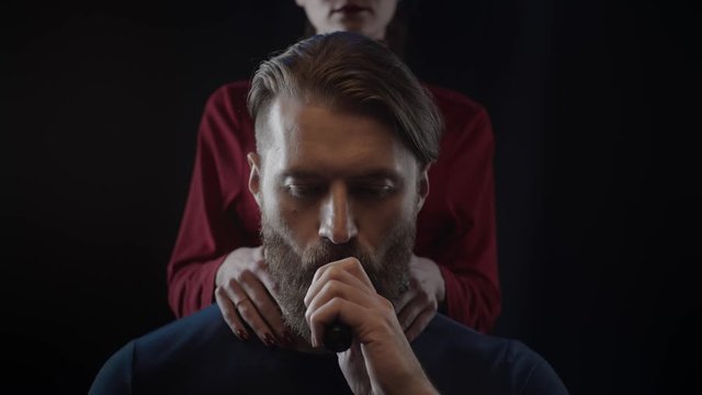 Bearded man smoking vape, woman touching beard of man with tender, slow motion