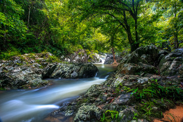 Obraz premium beautiful waterfall and emerald pool of fresh water lake in wild jungle forest environment in Thailand. Travel and adventure landscape of amazing Asia