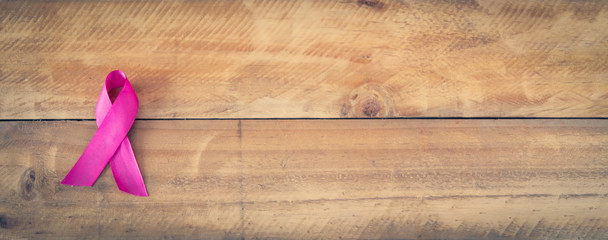 Pink ribbon for breast cancer awareness, symbolic bow color raising awareness on people living with women's breast tumor illness