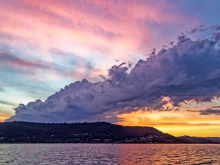 Colourful stormy pink and yellow coloured Cirrus cloudy coastal Sunset Seascape, Australia.