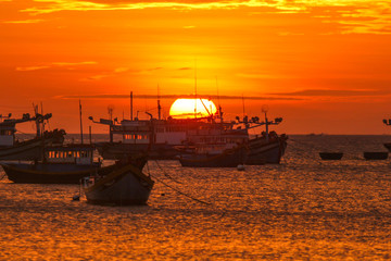 Fishing boats on the background of a golden sunset