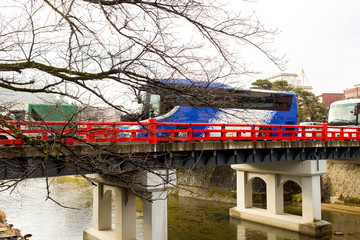 Bus service tour on red bridge in Takayama, Japan