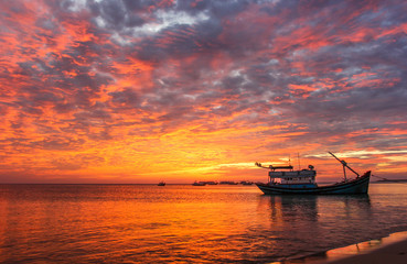 Fishing boats against the background of a purple sunset