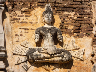 Fototapeta na wymiar Ancient stucco patterns ,Wat Chet Yot temple,B.E. 1998 King Tilokaraj The 9th King of the Mangrai Dynasty built of laterite decorated with stucco designs. Is a Bodh Gaya pagoda India.