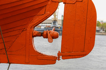 View of the embankment through the tiller and propeller of the lifeboat